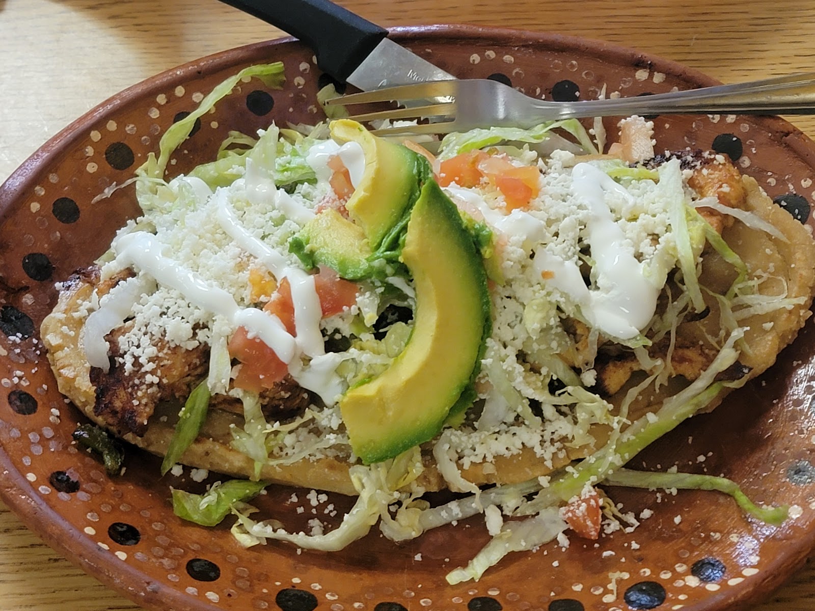 Tostada topped with avocado at Los Arcos Mexican Restaurant
