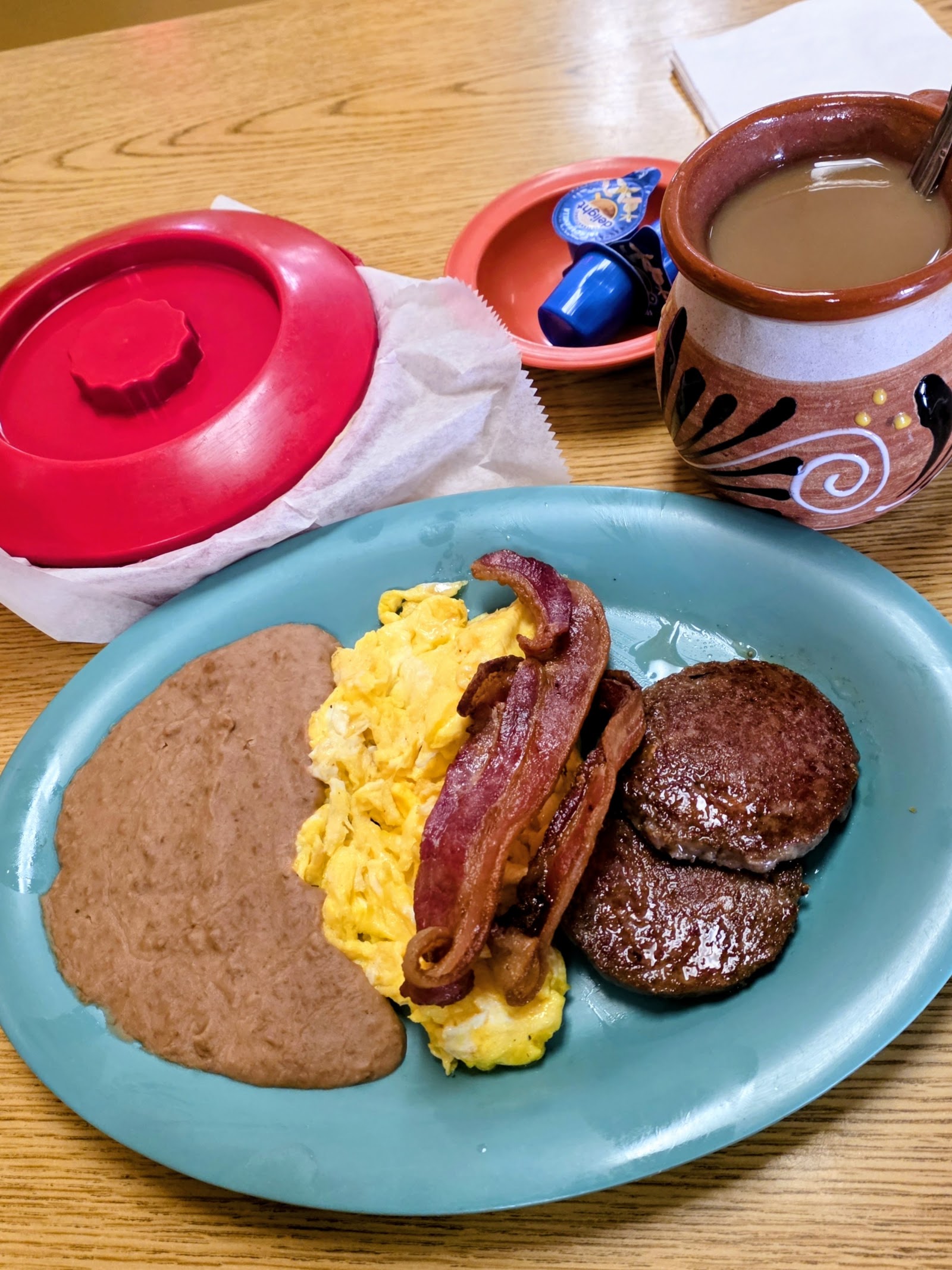 Breakfast plate with eggs, bacon, and beans at Los Arcos